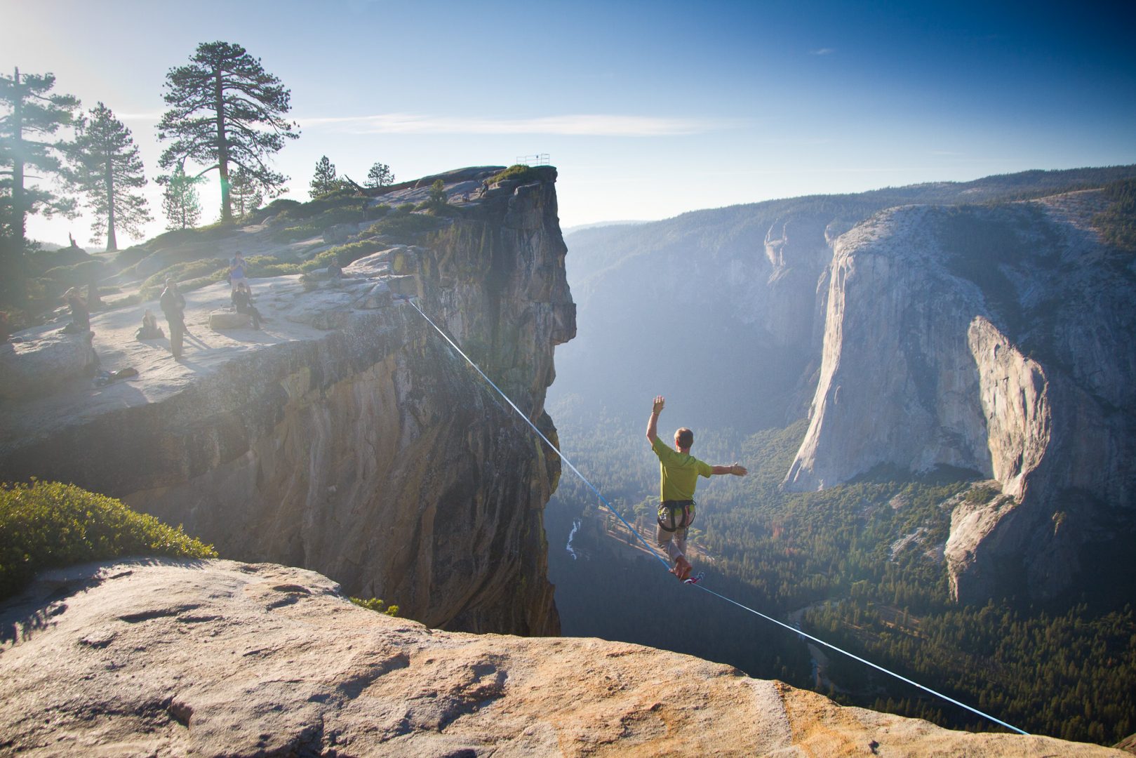 Homem cruzando uma corda bamba no mirante de Taft Point, no Parque Nacional Yosemite, na California