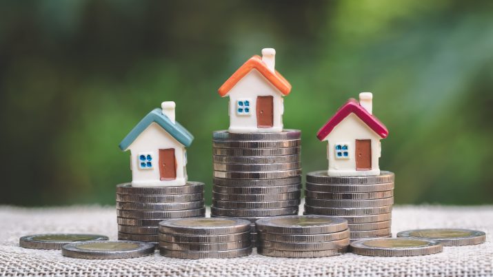 Mini,House,On,Stack,Of,Coins,,Concept,Of,Investment,Property,