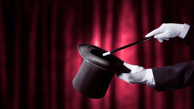 Magician,Holding,A,Top,Hat,And,Magic,Wand,With,A