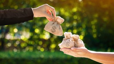 Businessman,And,A,Woman,Hands,Hold,A,Money,Bags,In