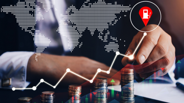 Um trader aponta com o dedo para cima de um gráfico com o preço do petróleo nas alturas; commodities em alta