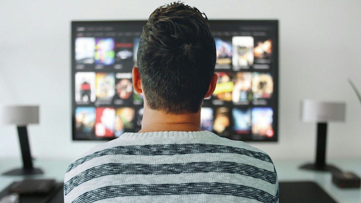 Televisão smart mostrando um homem assistindo gatonet
