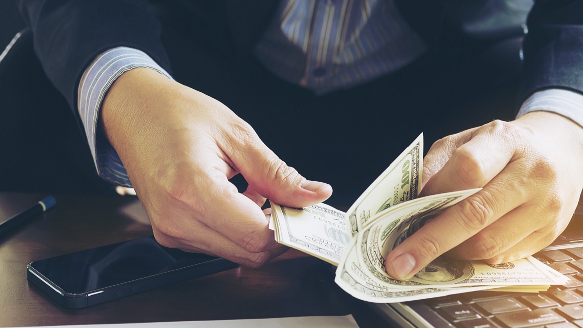 Business man counting dollar banknote – online business concept