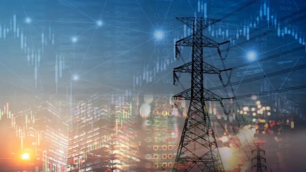 Montagem com torres de transmissão de energia com gráficos ao fundo | Dividendos