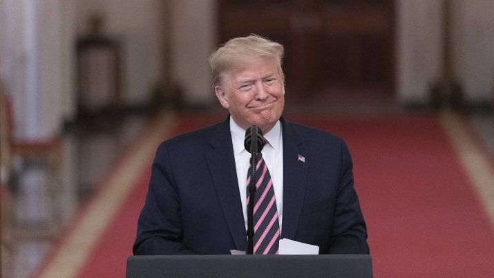 O presidente dos EUA, Donald Trump, parado em frente a um púlpito