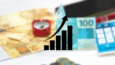 Montagem com notas de real e gráfico - renda fixa crescimento cdi