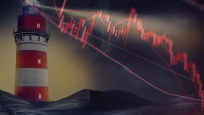 Gráfico de queda vermelho diante de um farol de mar turbulento