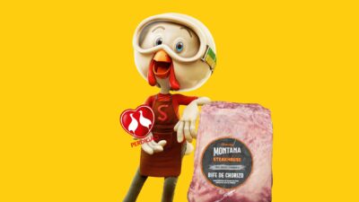 Mascote da Perdigão, uma galinha animada com capacete e óculos, aparece em fundo amarelo segurando uma embalagem de carne Montana Steakhouse Bife de Chorizo, destacando produtos da marca.