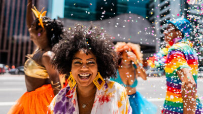 Portrait of a mid adult woman having fun with friends at the street carnival