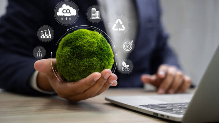 World environment day, Responsibility for a green planet, Sustainable growth, and global conservation.Businessman holding green world, Sustainable development goals and corporate social responsibility