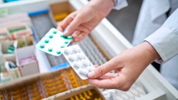Female pharmacist holding medicines