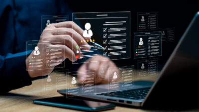 HR management with AI recruiting technology concept: Businessman uses a laptop recruitment process to check the scores and qualifications of applicants through an online system, Best human resource