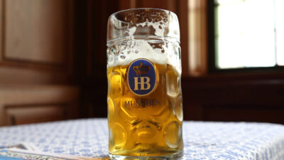 Munich, Germany - September 11, 2012: A mug of beer from the world famous Hofbräuhaus in Munich, Germany. Hofbräuhaus was founded in 1589 by Wilhelm V, the Duke of Bavaria. The symbolic "HB" logo is synonymous with Hofbräuhaus and its beer.