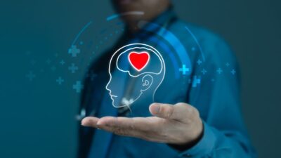 Ilustração com uma mão e uma pessoa que remete à saúde mental