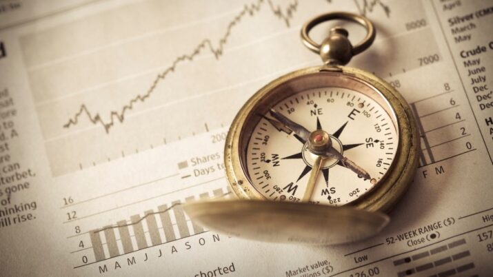 Bússola e gráficos de investimentos