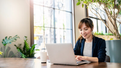 Portrait smile beautiful business asian woman in pink suit working in office desk virtual computer. Small business owner people employee freelance online sme marketing e-commerce telemarketing concept