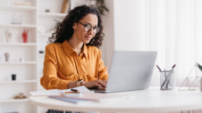 Middle Eastern Lady Using Laptop Working Online Sitting In Office