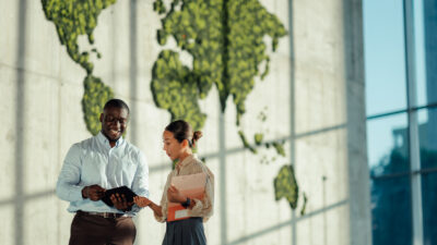 Business colleagues discussing global strategies in modern office