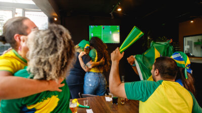 group of Brazilian friends, celebrating a Brazilian goal.