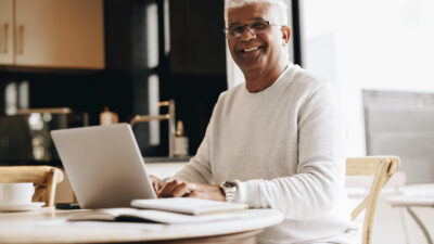Happy senior man working from home