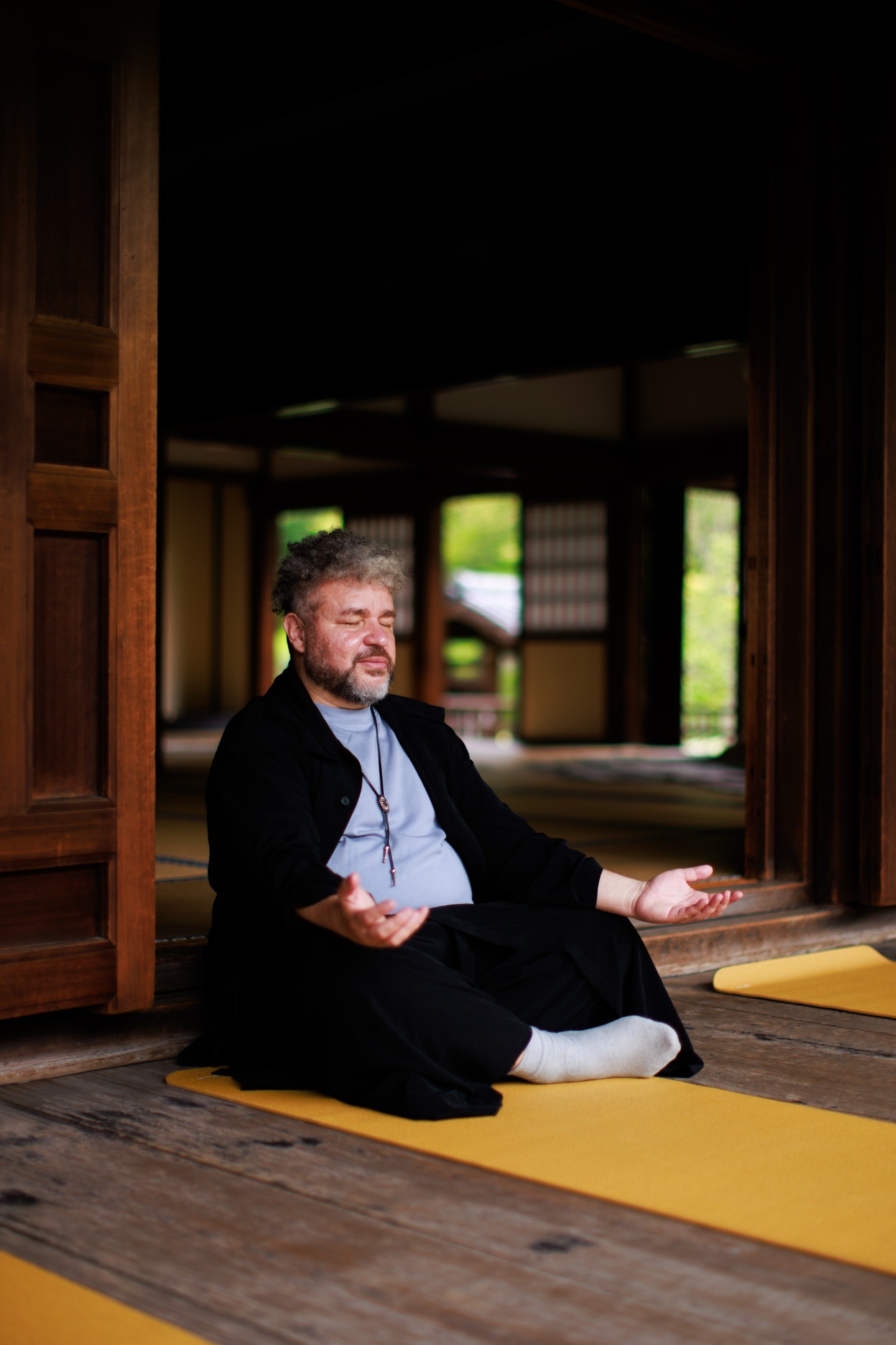 roberto maxwell sentado em templo no japão em posição de meditação