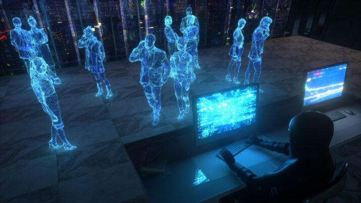 Imagem mostra um robô analisando um computador e hologramas azuis de pessoas ao fundo, para mostrar uma visão futurista de segurança digital