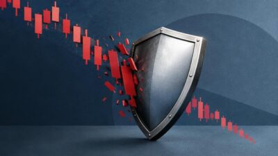 Escudo metálico bloqueando um gráfico de candlesticks vermelhos em queda sobre fundo azul.